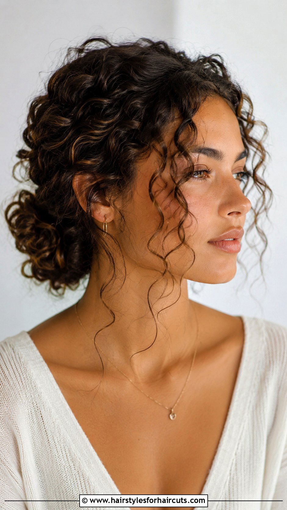 Curly Bun With Face Framing Pieces - 25 work hairstyles for curly hair - 25 work hairstyles for curly hair