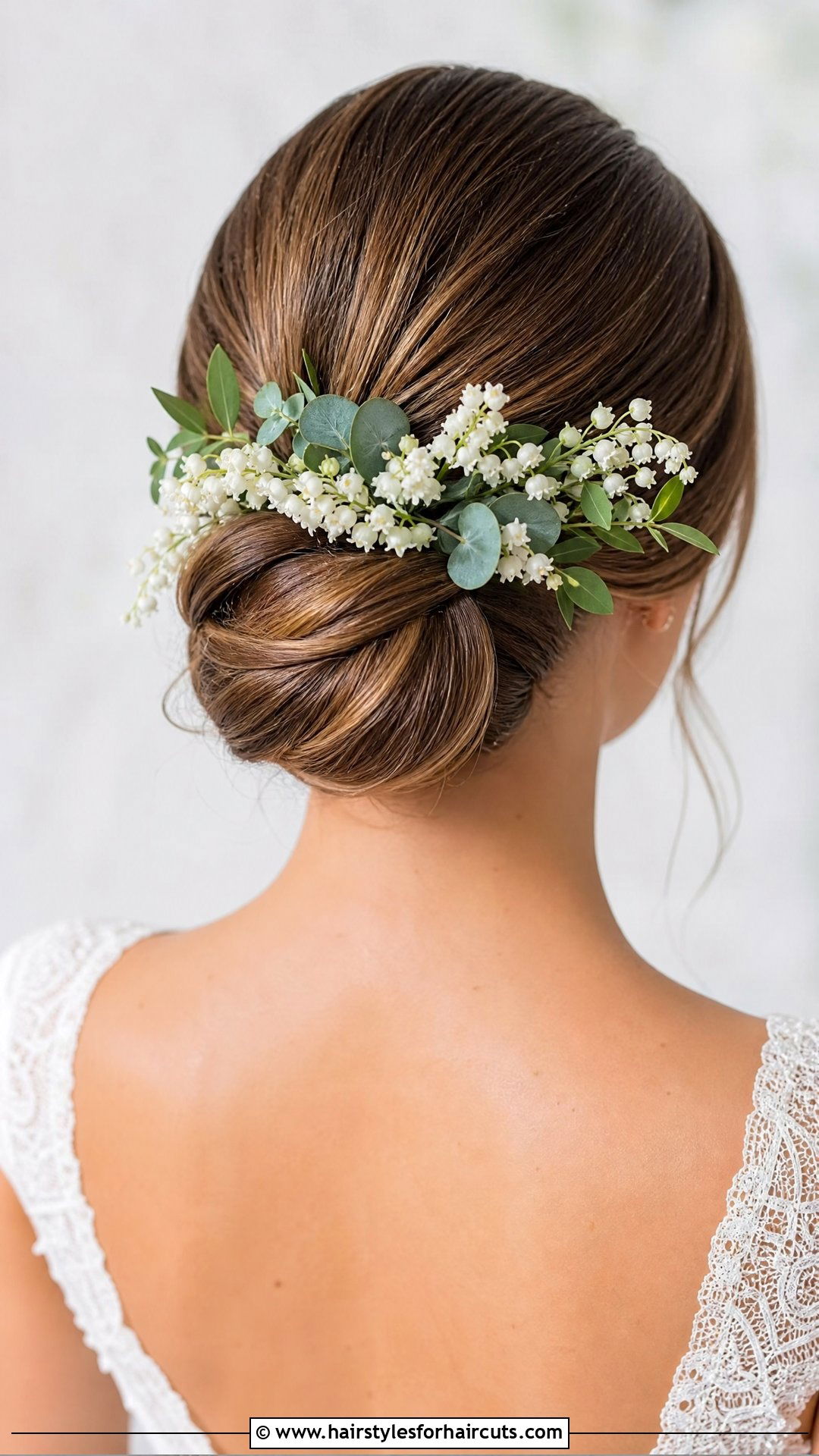 Low Chignon With Greenery And White Blooms - 25 flowers in hairstyles - 25 flowers in hairstyles