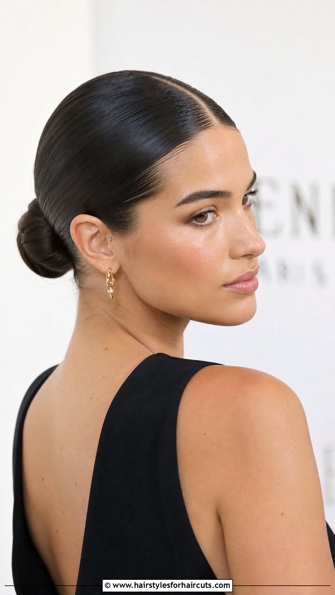 Sleek Low Bun With Center Part - 25 holiday hairstyles - 25 holiday hairstyles